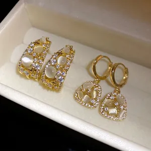 14k gold plated C-shaped and drop earrings set with cubic zirconia and cat's eye stones
