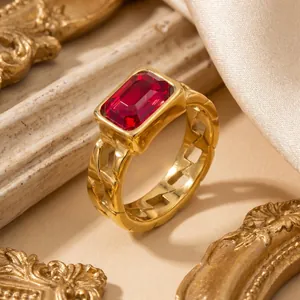 Detailed view of retro gold ring with rectangular red zircon and chain-link band