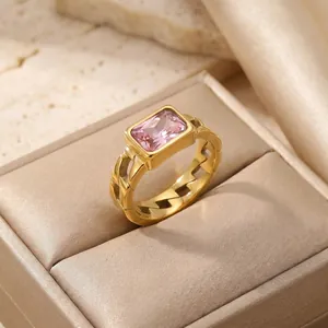 Detailed view of elegant gold stainless steel ring with pink zircon and Cuban link band