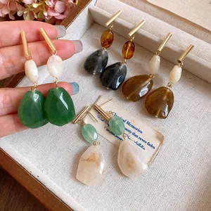 Macro detail of vintage resin geometric drop earrings featuring multiple elegant colors