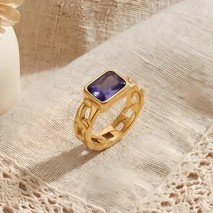 Detailed view of a gold cuban link ring featuring a radiant purple rectangle zircon.