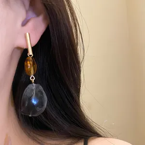 Detailed close-up of vintage geometric resin drop earrings with silver needle post