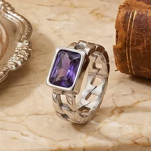 Detailed view of a retro titanium steel ring with a rectangular purple zircon gemstone
