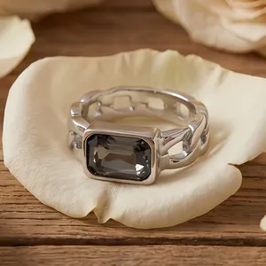 Close-up of vintage stainless steel Cuban link ring with a dark grey rectangular gemstone