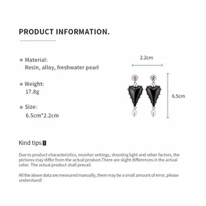 Detail of resin heart earrings with pearls showing material and size measurements