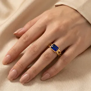 Close-up detail of retro titanium steel ring with blue square zircon on a model hand