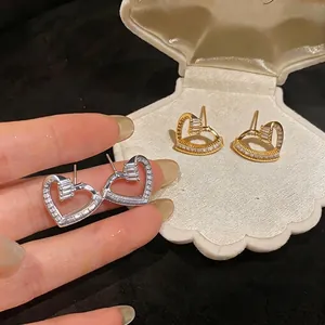 Elegant French style twisted heart stud earrings with sparkling zircons in gold and silver