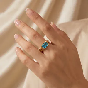 Close-up of gold stainless steel Cuban chain ring with a blue rectangle zircon stone