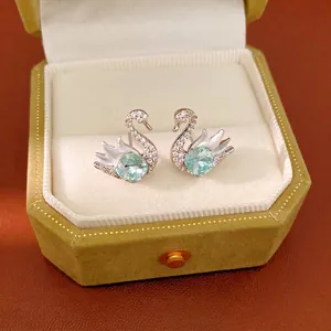 Elegant silver swan stud earrings with sparkling blue square crystals and pave stones
