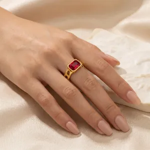 Close-up of a vintage rectangular red zircon ring in 18K gold plating on a hand