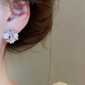 Detail of elegant French floral cluster earrings featuring pearls and crystal accents