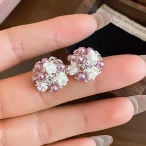 Close-up of French floral cluster pearl earrings with sparkly rhinestones