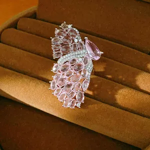 Detailed close-up of a luxury butterfly wing open ring with pink zircons on velvet tray