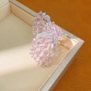 Detailed macro view of a pink zircon butterfly wing adjustable ring inside a gift box