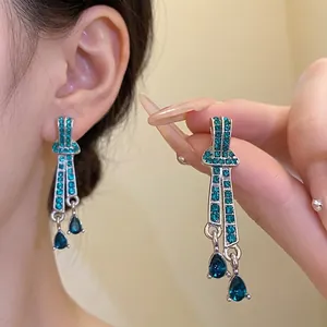 Vintage silver needle earrings with emerald green rhinestones and water drop pendants