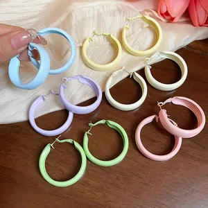 Macro view of macaron-colored dopamine painted hoop earrings in various shades