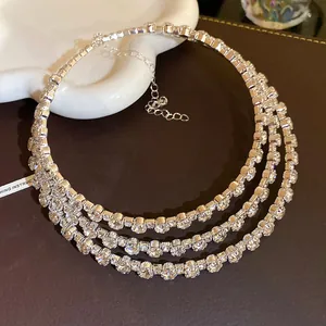 Detailed view of luxury three-layer rhinestone choker necklace in silver finish