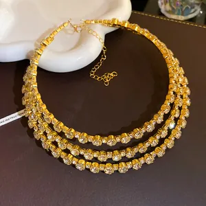 Detailed view of a gold-plated three-layer crystal choker necklace with sparkling stones.