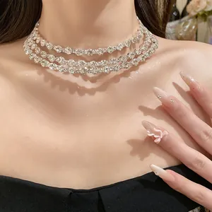 Close-up detail of an elegant three-layer sparkling rhinestone choker necklace on a model's neck