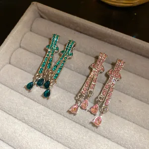 Detailed close-up of retro teardrop crystal dangle earrings with sparkling silver needle posts