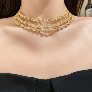 Close-up of a glamorous three-layer gold-tone choker necklace with round crystals