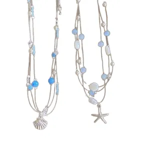 Blue beaded layered necklace with silver starfish and shell pendants for seaside vacation