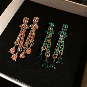 Vintage elegant teardrop pendant earrings with pink and green rhinestones in gift box.