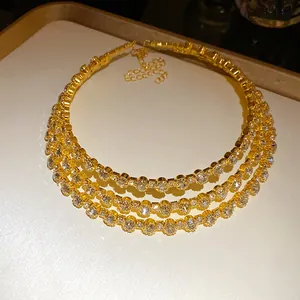 Detailed view of a luxury three-layer gold-plated choker necklace with circular rhinestones
