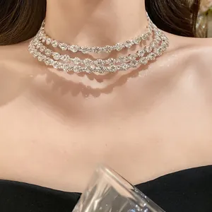 Close-up detail showing the sparkling silver finish of a three-layer rhinestone choker necklace.