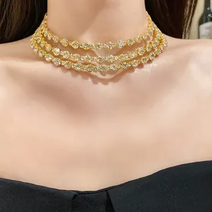 Close-up of luxury three-layer gold choker necklace with sparkling round diamonds