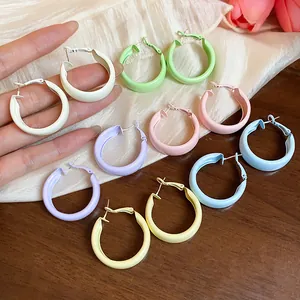 Detailed view of colorful matte spray paint hoop earrings in pastel dopamine colors