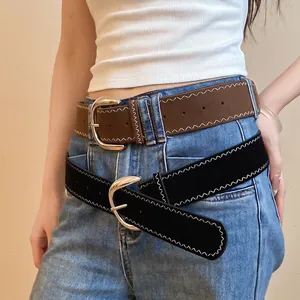 Trendy black leather belt with white zig-zag stitching and silver metal buckle