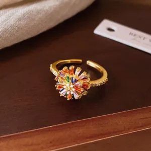 Close-up of elegant gold-plated open ring featuring a vibrant crystal flower design.