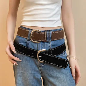 Close-up detail of women's leather belt featuring a silver buckle and zigzag stitching.