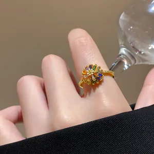 Detailed close-up of a vibrant flower ring featuring colorful crystal petals and gold