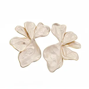 Elegant white enamel flower stud earrings with gold trim in a vintage French style.