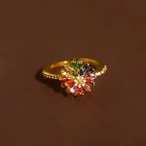 Detail of gold adjustable ring featuring a vibrant multi-colored gemstone flower design
