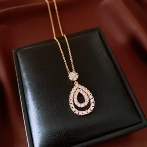 Detail shot of elegant vintage teardrop CZ pendant necklace on black gift box display