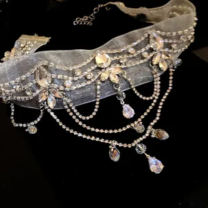 Detailed view of elegant chiffon choker with cascading rhinestone tassels and crystal drops