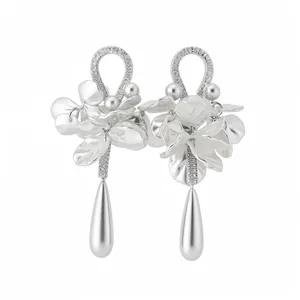Elegant silver-toned floral earrings with zircons, pearls, and teardrop pendants.