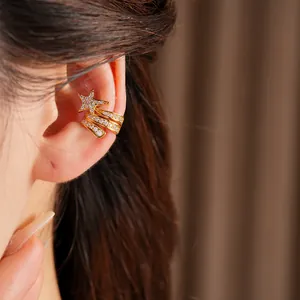 Close-up detail of a gold triple-layer star ear cuff set with sparkling zircons