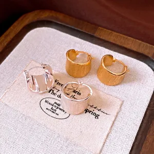 Minimalist 18k gold plated brushed metal hoop earrings in gold and silver finish.