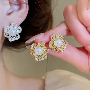 Vintage hollow flower earrings with white pearl and zircon accents