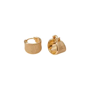 Minimalist 18k gold plated brushed hoop earrings featuring a unique textured matte finish