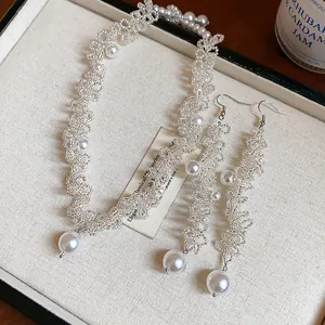 Detailed close-up of a delicate handcrafted beaded pearl necklace and earrings set in a jewelry box