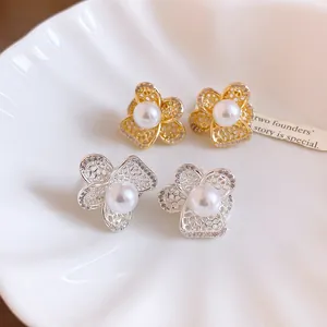 Macro detail of French vintage pearl flower earrings with hollow zircon petals