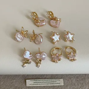 Collection of elegant gold earrings with pink pearls, stars, and zircon details