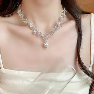 Close-up of elegant French style beaded lace necklace with hanging pearl pendant