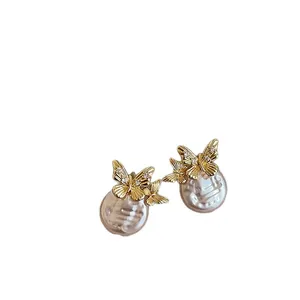 Elegant golden butterfly and pearl stud earrings with sparkling zircon accents.