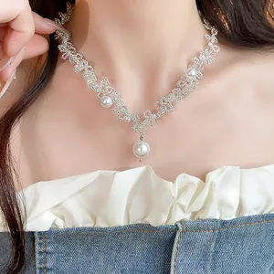Detail shot of an elegant French style pearl beaded necklace on a model for high end fashion